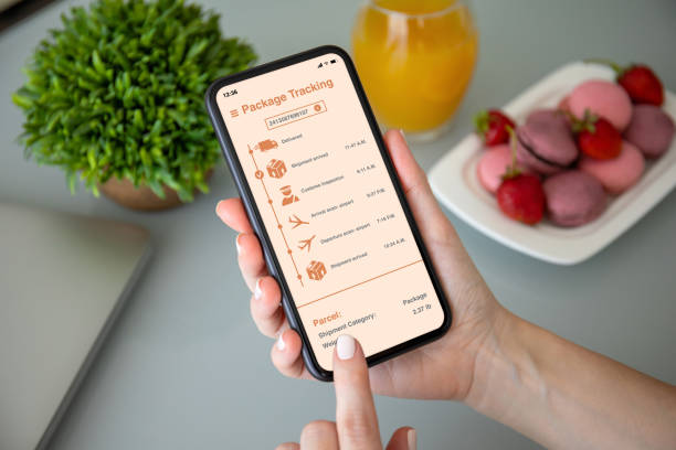 istock female hand holding phone with app tracking delivery package 1220306407