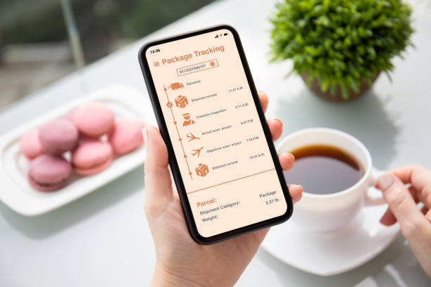 istock female hand holding phone with app tracking delivery package 1220308577