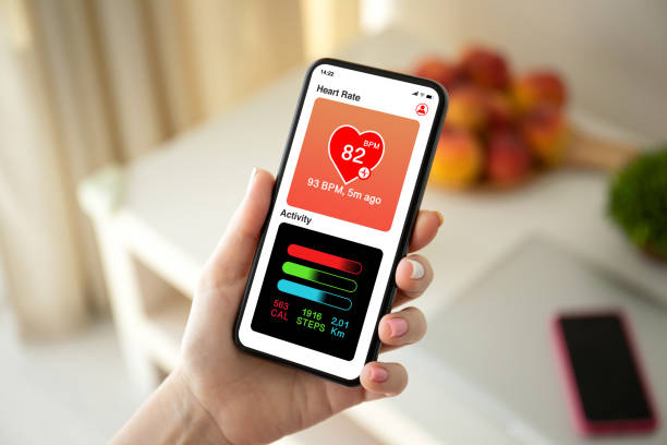 istock female hand holding phone with app heart and activity 1220308857