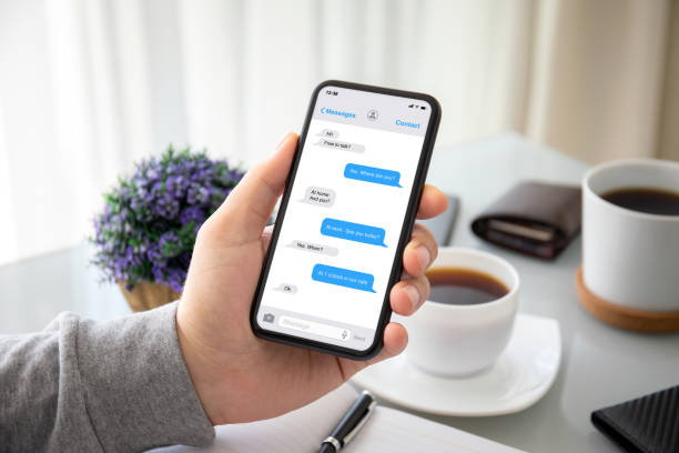 istock male hands holding phone with app messenger on the screen 1220309115