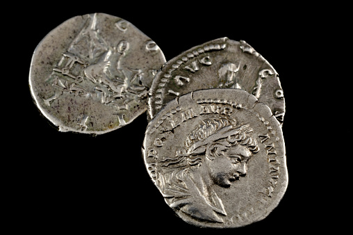 macro of roman silver coins isolated on black background
