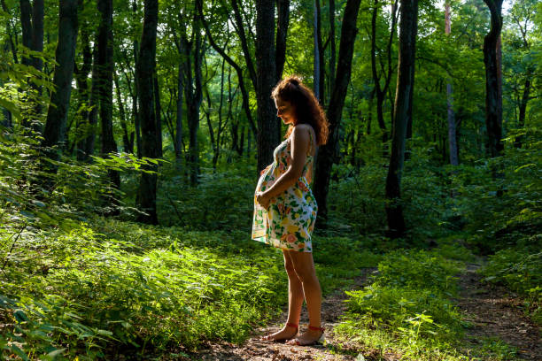I love every minute of being pregnant. Beauty pregnant woman in nature.