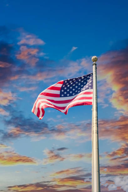 istock American Flag Up Flagpole at Sunset 1220311073