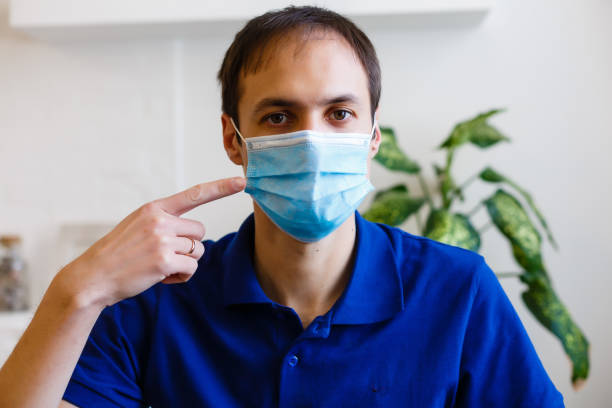 istock man wearing protective mask. coronavirus 2019-nCoV 1220311344