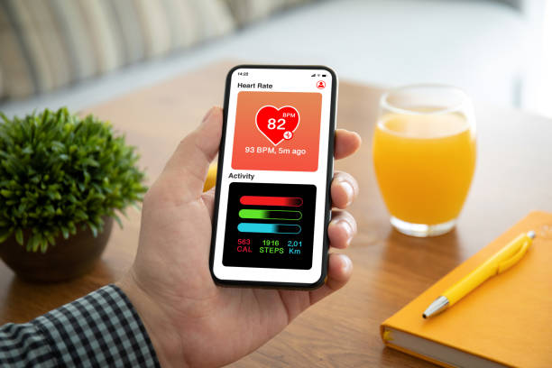 istock male hand holding phone with app heart and activity 1220311961