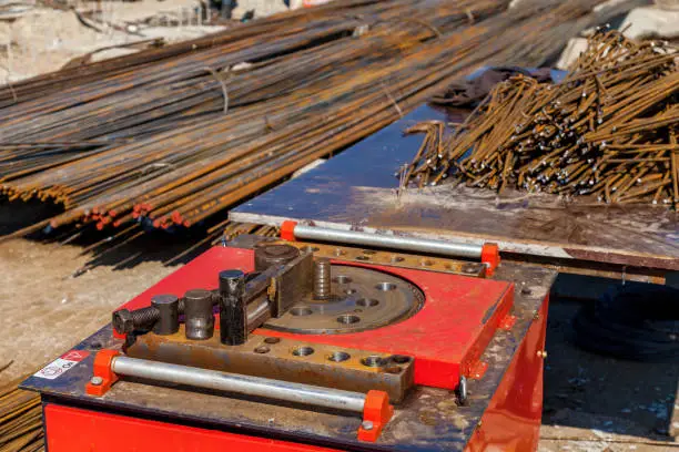 A close-up view of a specific machine using for bending of armatures at the construction site.