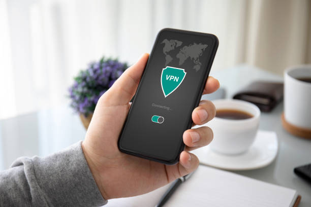 istock male hand holding phone with app vpn on the screen 1220312403