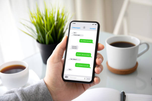 istock male hands holding phone with app messenger on the screen 1220312690
