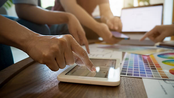 istock Graphic design and color swatches and pens on a desk. Architectural drawing with work tools and accessories. 1220313909