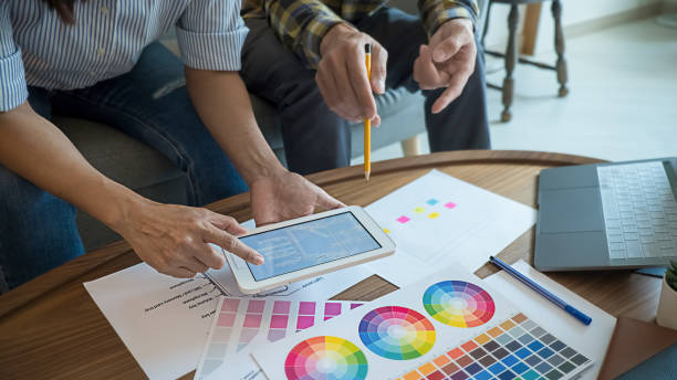 istock Graphic design and color swatches and pens on a desk. Architectural drawing with work tools and accessories. 1220313917