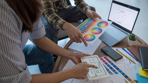 istock Graphic design and color swatches and pens on a desk. Architectural drawing with work tools and accessories. 1220313918