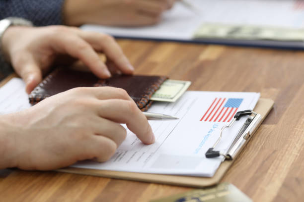 male hands in suit lie on application for usa visa - petition imagens e fotografias de stock