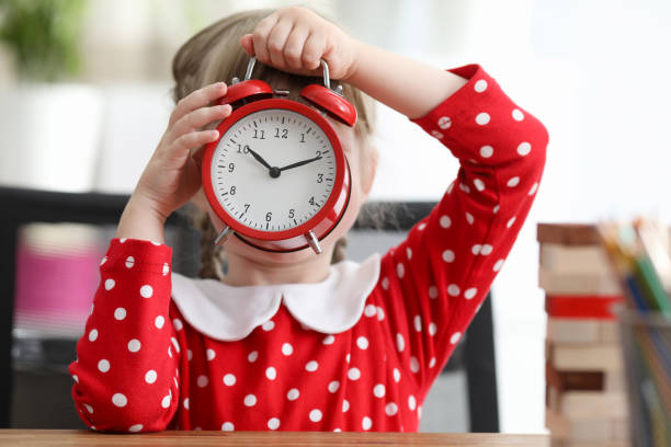 istock Baby dress covered her face with large alarm clock 1220314871