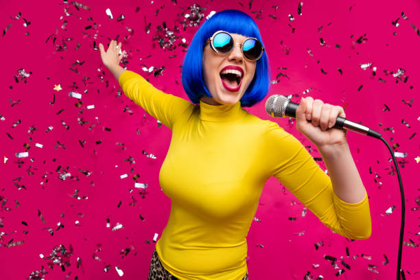 Closeup photo of funny nice lady singer party night club microphone karaoke confetti falling wear specs yellow turtleneck blue wig isolated bright pink color background Closeup photo of funny nice lady singer party night club microphone, karaoke confetti falling wear specs yellow turtleneck blue wig isolated bright pink color background karaoke stock pictures, royalty-free photos & images