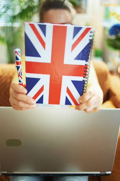 istock learner woman with laptop holding notebook in front of head 1220316554