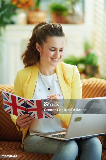 Happy Learner Woman With Laptop Taking Notes In Notebook Stock Photo - Download Image Now