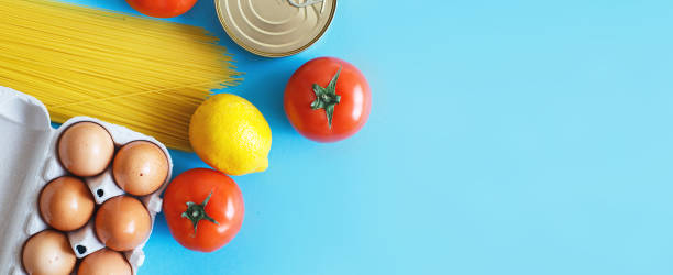 istock Different healthy food products on a blue background. Top view. fruit, vegetable, eggs and grocery online shop. Banner 1220320314