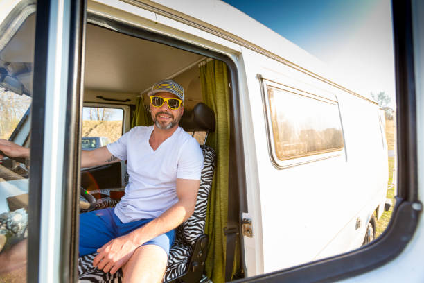 istock Portrait Of Man Sitting In Camper Van 1220320360