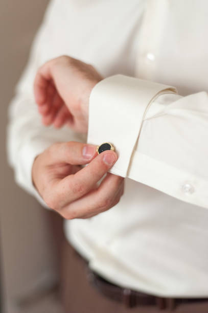 istock Men's hands adjust cufflinks on the sleeves. 1220320593
