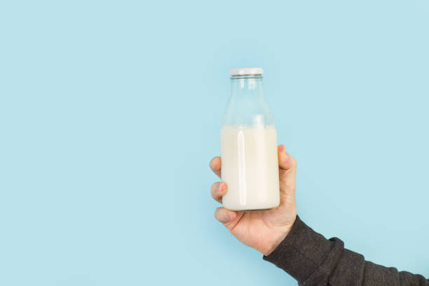 istock Man hand holding a bottle of milk 1220322942