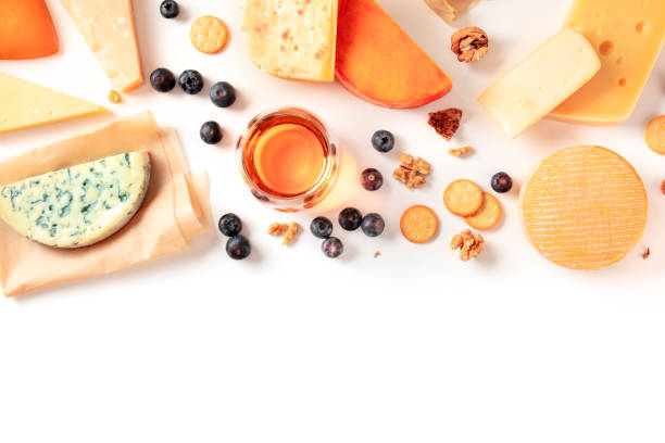 istock Cheese and wine tasting and pairing flat lay on a white background with copy space. Many different cheeses, shot from the top 1220323402