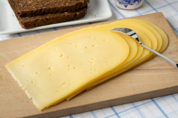 Slices of young Gouda cheese close up for breakfast