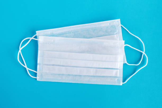 istock Medical face masks on blue background. 1220327190
