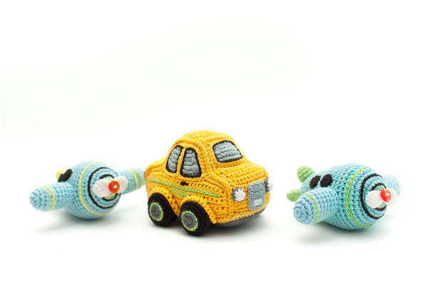 istock small knitted blue planes and a yellow baby car 1220327312