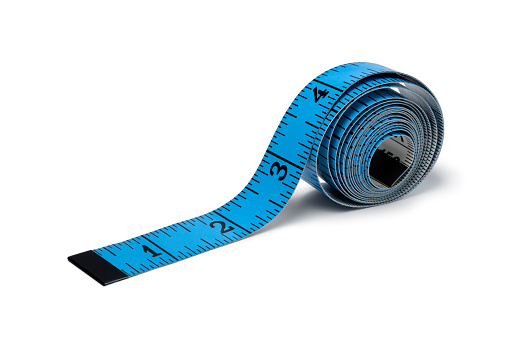 Blue measuring tape in inches close up isolated on white background