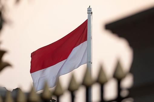 Jakarta, Indonesia - July 13, 2019: Close-up of the Indonesian national red and white flag next to Medan Merdeka Utara avenue in the Central Jakarta district.