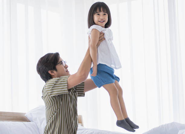 istock Daddy playing with his daughter at home 1220328499