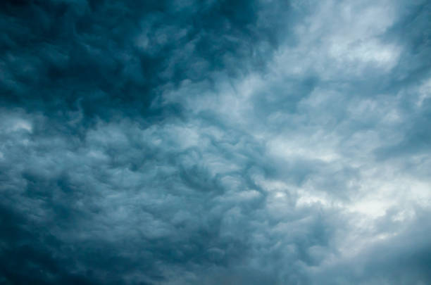 istock Dark blue ominous storm clouds close up overhead. Dramatic sky background. Horizontal orientation. 1220328812