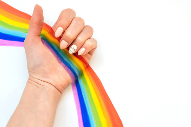 istock hand with unicorn manicure on white background 1220329574