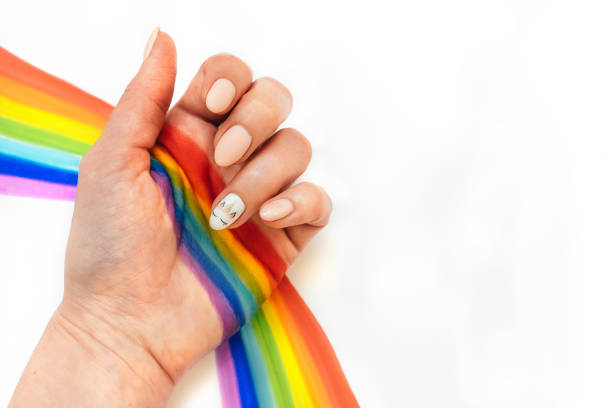 istock hand with unicorn manicure on white background 1220329576