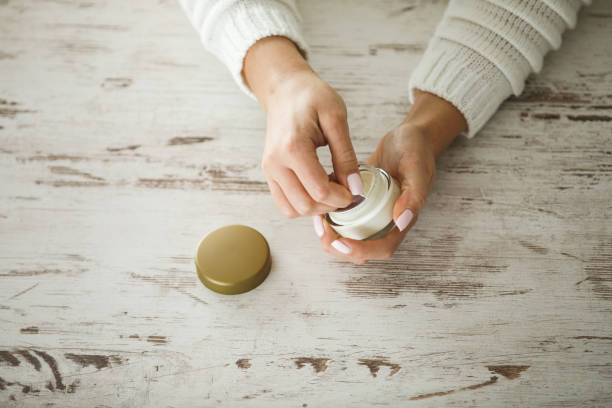 istock Removing protective foil of a cream jar 1220330595