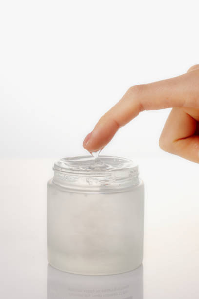istock Cosmetics glass containers with gel cream and hands used. 1220330661