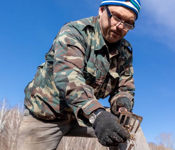 istock a man, a white European, in gardening work clothes and carrying a tool. 1220330903