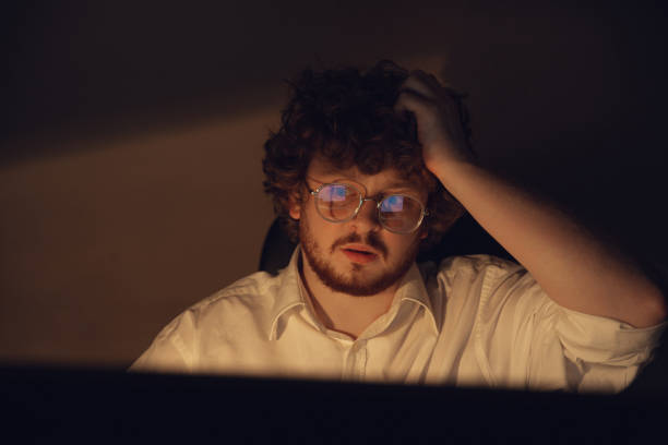 istock Man working in office alone during coronavirus or COVID-19 quarantine, staying to late night 1220334222
