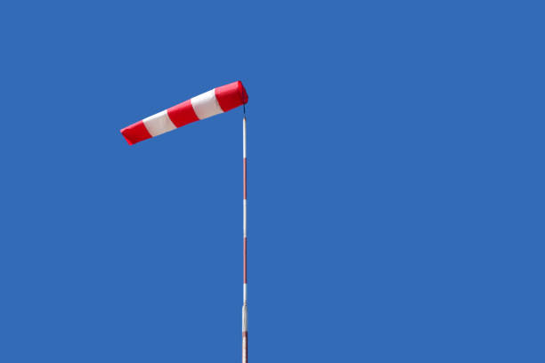 Airport windsock on clear blue sky background in windy weather indicate the local wind direction. at airfield for flying aircraft pilot direction information