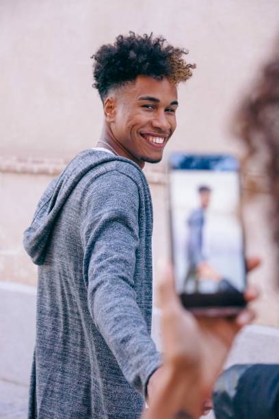 istock girlfriend uploading a picture of her boyfriend 1220334393