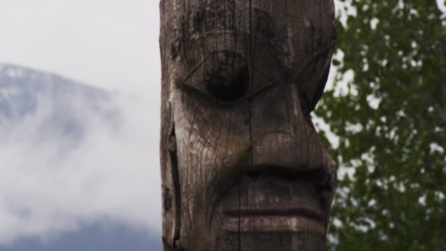Totem poles in beautiful landscape in Alaska