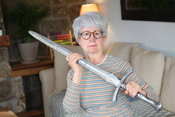 istock Senior woman holding a sword 1220339663