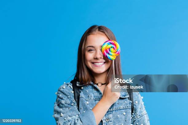 Cheerful Teenege Girl Holding Lollipop Stock Photo - Download Image Now - Lollipop, Teenager, Adolescence