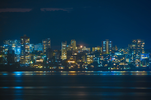 Boston, United States – December 28, 2021: The cityscape of Boston with the Charles river reflecting the city lights at night. United States.