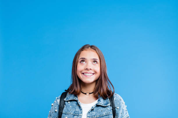 istock Excited pretty teenege girl looking up 1220341066