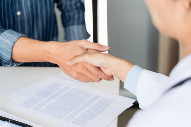 istock Midsection Of Doctor Shaking Hands With Patient 1220342138