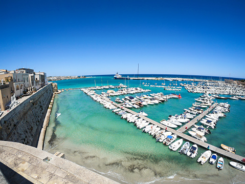 sunny view of Otranto, coastal town in Puglia with turquoise sea. Italian vacation