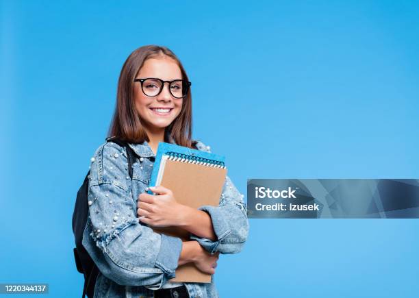 Portrait Of Female High School Student Holding Books Stock Photo - Download Image Now