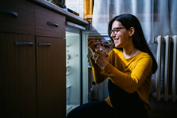 istock Young woman having a midnight snack 1220344598