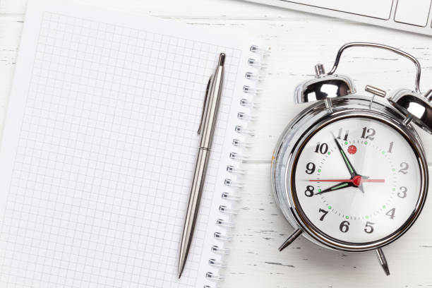 istock Workplace with supplies and alarm clock 1220344608